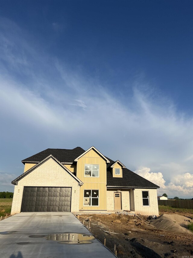 13510 Smarty Jones Dr, Scott, AR 72142 - property under construction featuring concrete driveway, a garage, brick siding, and roof with shingles