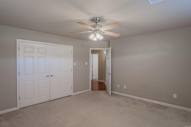 unfurnished bedroom with a closet, ceiling fan, and light carpet