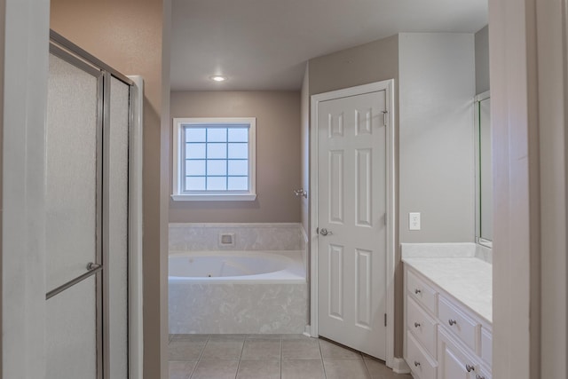 bathroom with tile patterned flooring, shower with separate bathtub, and vanity