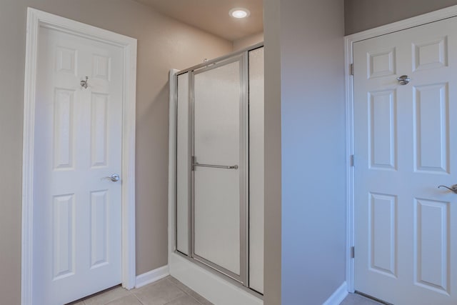 bathroom with tile patterned floors and an enclosed shower