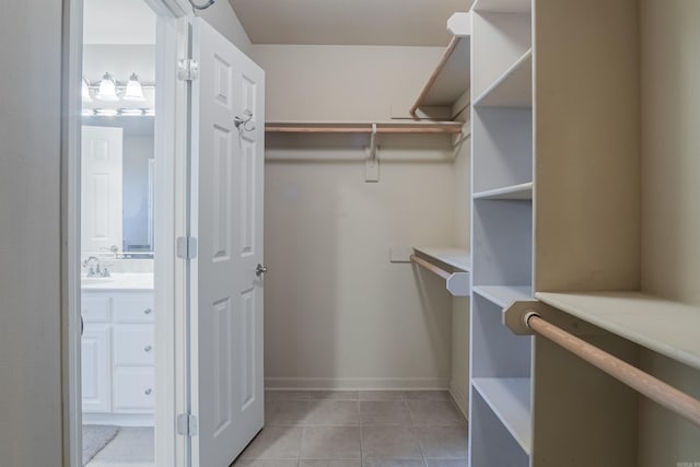 walk in closet featuring light tile patterned flooring