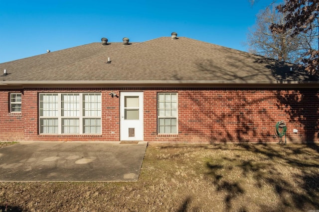 rear view of house with a yard and a patio