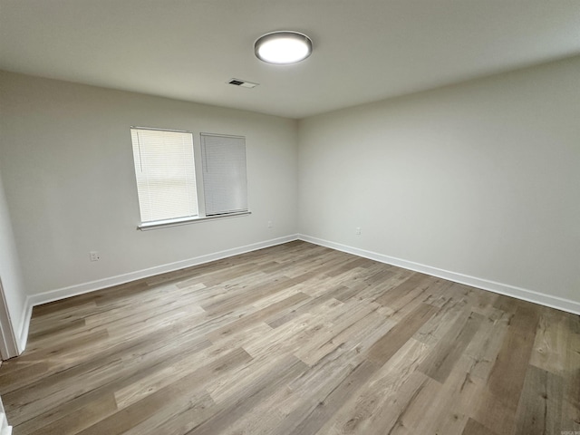 spare room featuring light hardwood / wood-style flooring