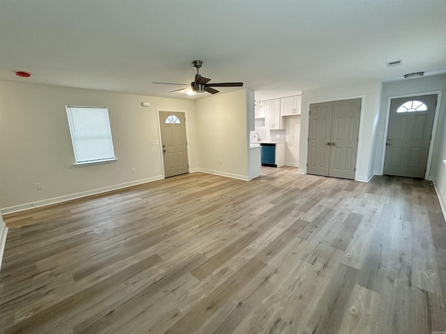 unfurnished living room featuring light hardwood / wood-style floors and ceiling fan