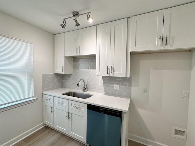 kitchen featuring stainless steel dishwasher, sink, white cabinets, light hardwood / wood-style flooring, and backsplash