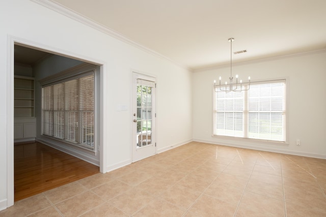 empty room featuring crown molding, light tile patterned floors, and an inviting chandelier