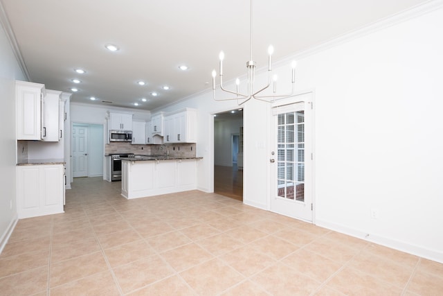 kitchen featuring crown molding, pendant lighting, white cabinets, a notable chandelier, and stainless steel appliances