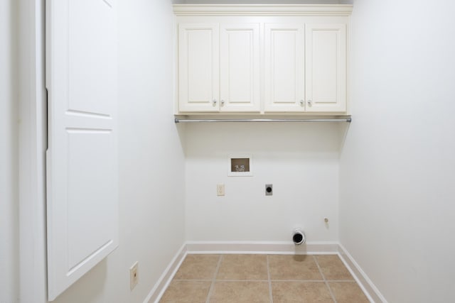 laundry room featuring cabinets, washer hookup, light tile patterned floors, and electric dryer hookup