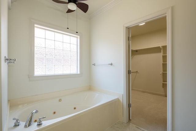 bathroom with ceiling fan, a tub, and ornamental molding