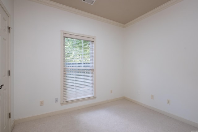 empty room with ornamental molding and carpet floors