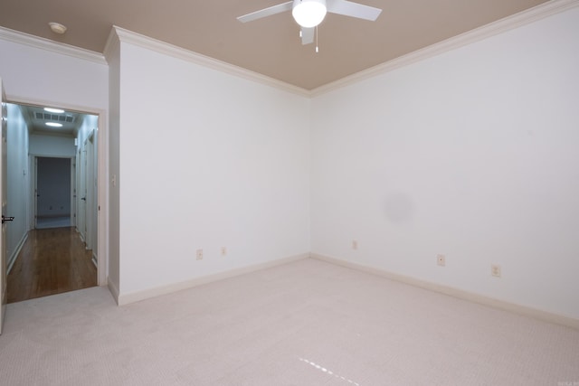 carpeted empty room featuring crown molding and ceiling fan