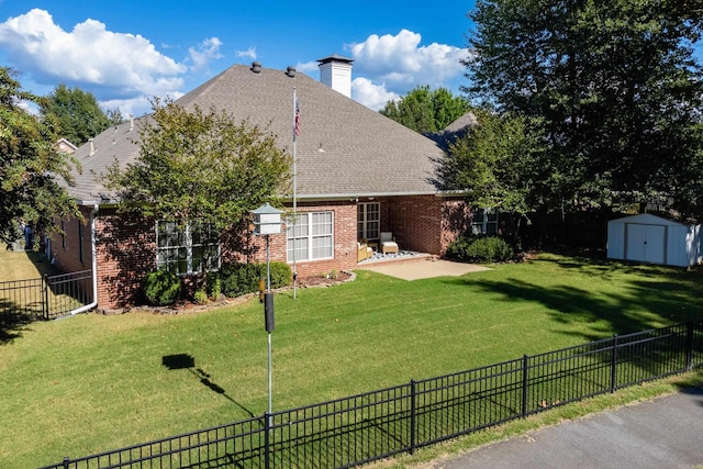 back of house featuring a patio area, a lawn, and a shed