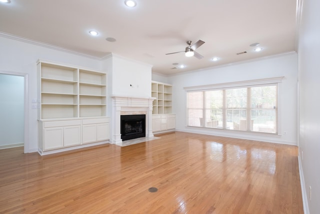 unfurnished living room with crown molding, light wood-type flooring, and ceiling fan