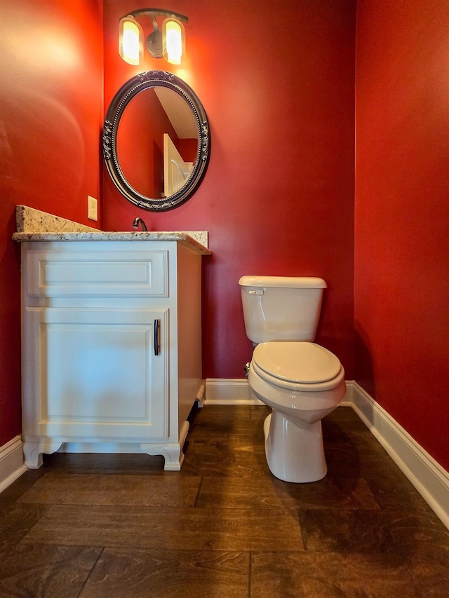 bathroom featuring hardwood / wood-style flooring, vanity, and toilet