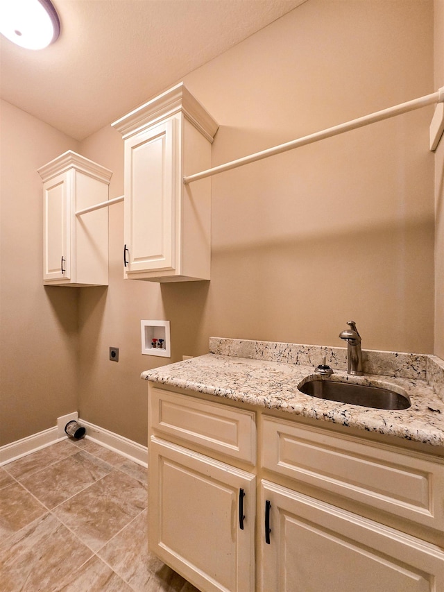 washroom with cabinets, hookup for a washing machine, sink, and hookup for an electric dryer