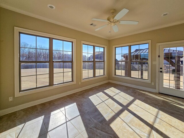 unfurnished sunroom featuring ceiling fan