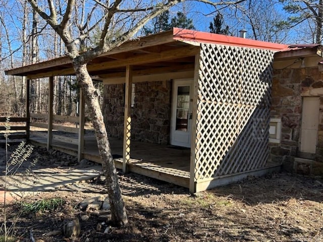 view of side of property featuring a wooden deck