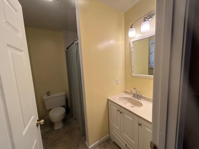 bathroom featuring toilet and vanity