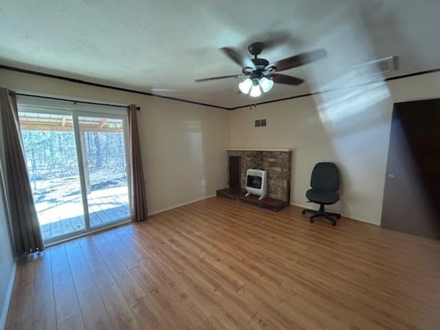 unfurnished living room with ceiling fan, hardwood / wood-style floors, and a fireplace