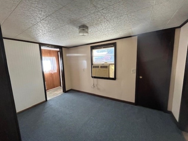 carpeted empty room featuring cooling unit and plenty of natural light