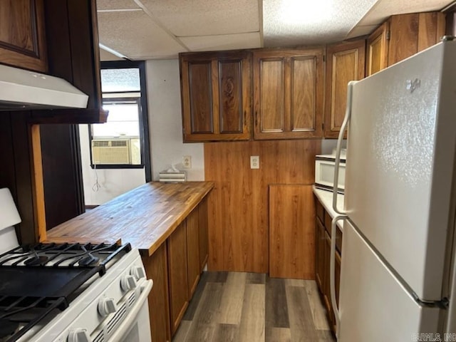 kitchen with white appliances, cooling unit, a drop ceiling, and light wood-type flooring