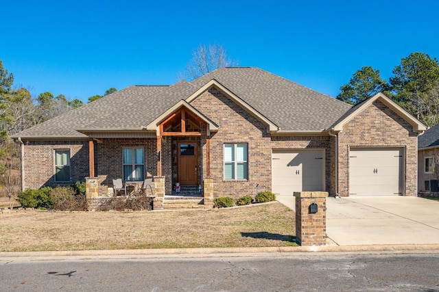 craftsman-style home featuring a porch, a garage, and a front yard