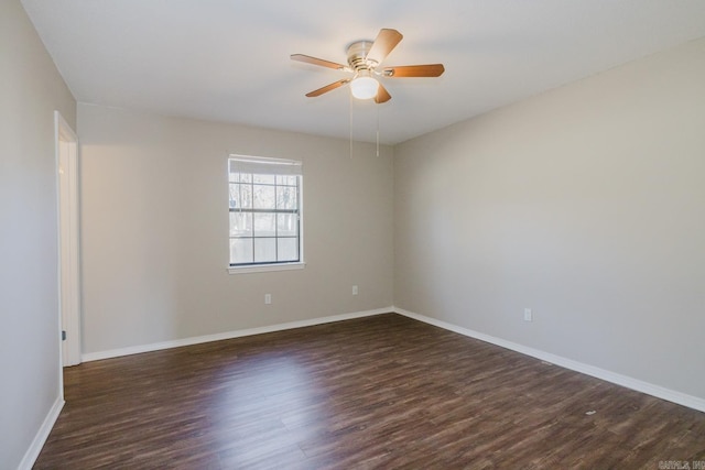 empty room with ceiling fan and dark hardwood / wood-style flooring