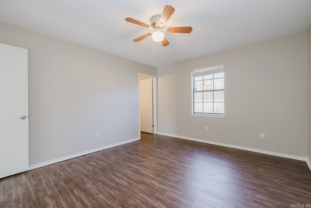 empty room with ceiling fan and dark hardwood / wood-style floors