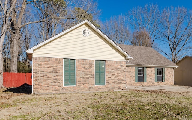 view of side of home featuring a patio area and a yard