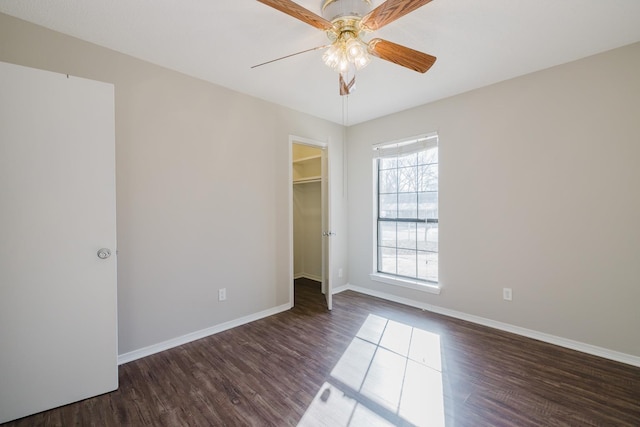 unfurnished room featuring dark hardwood / wood-style floors and ceiling fan