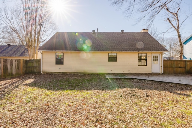 back of property with a patio area and a yard