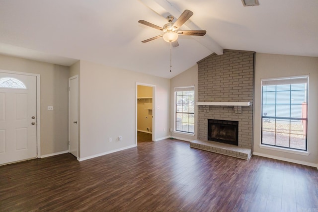 unfurnished living room featuring a fireplace, dark hardwood / wood-style flooring, ceiling fan, and vaulted ceiling with beams