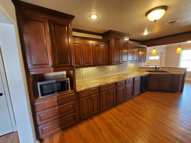 kitchen with pendant lighting, black dishwasher, decorative backsplash, sink, and ornamental molding