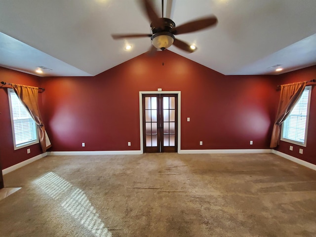 unfurnished living room with ceiling fan, carpet flooring, lofted ceiling, and french doors