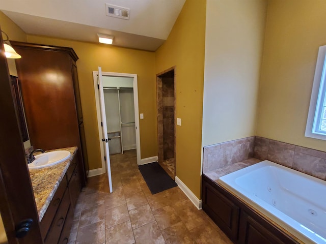 bathroom with separate shower and tub and vanity