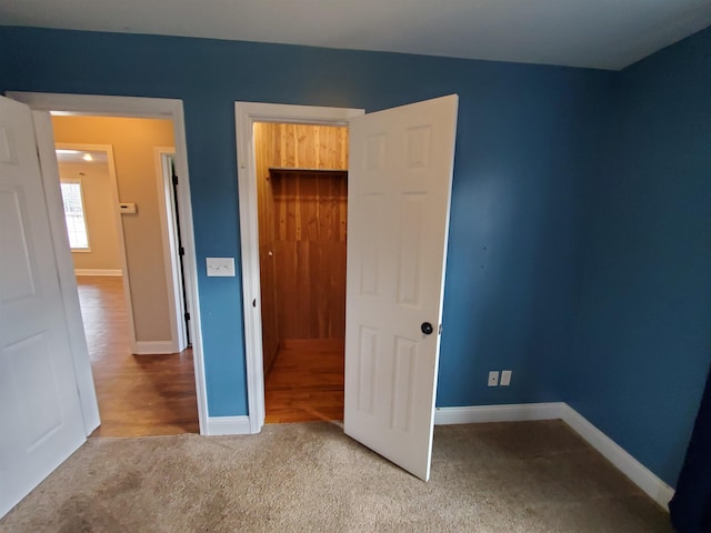 unfurnished bedroom featuring carpet flooring and a closet