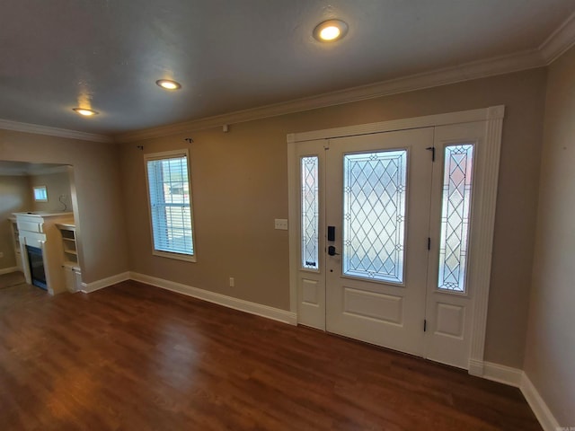 foyer entrance with dark wood-type flooring and ornamental molding