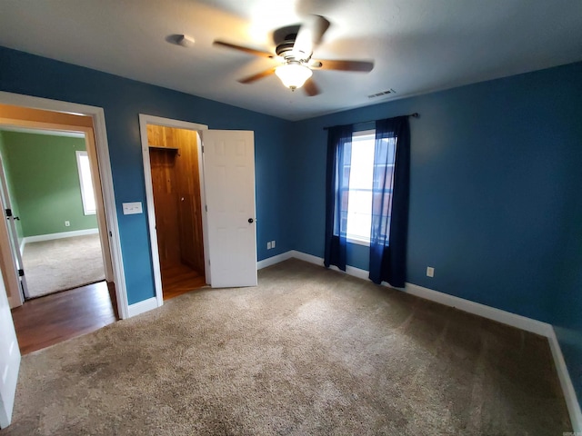 unfurnished bedroom featuring ceiling fan and carpet flooring