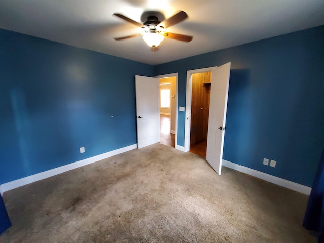 unfurnished bedroom with ceiling fan and carpet