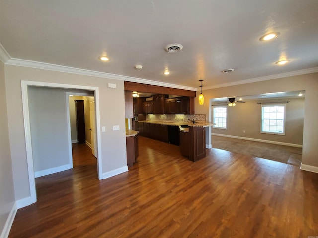 kitchen featuring decorative light fixtures, crown molding, dark hardwood / wood-style floors, and decorative backsplash