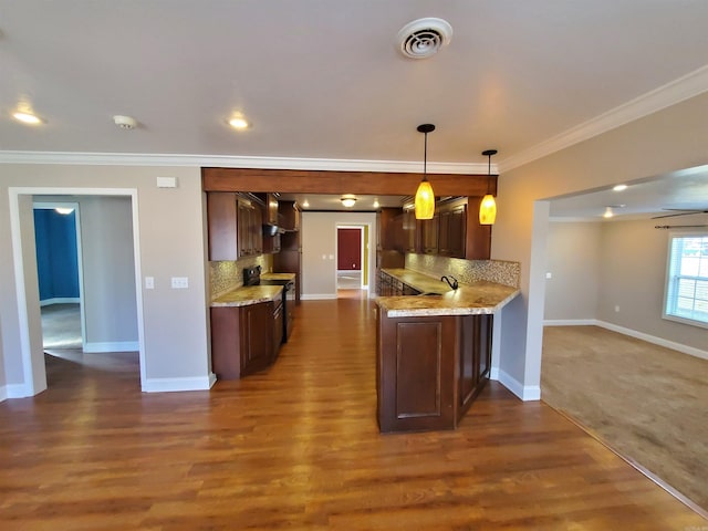 kitchen featuring hanging light fixtures, decorative backsplash, black range with electric stovetop, kitchen peninsula, and dark hardwood / wood-style floors