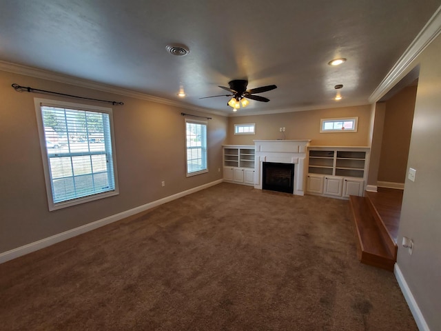 unfurnished living room with plenty of natural light, ornamental molding, and dark colored carpet