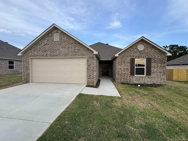 view of front of home featuring a garage and a front yard