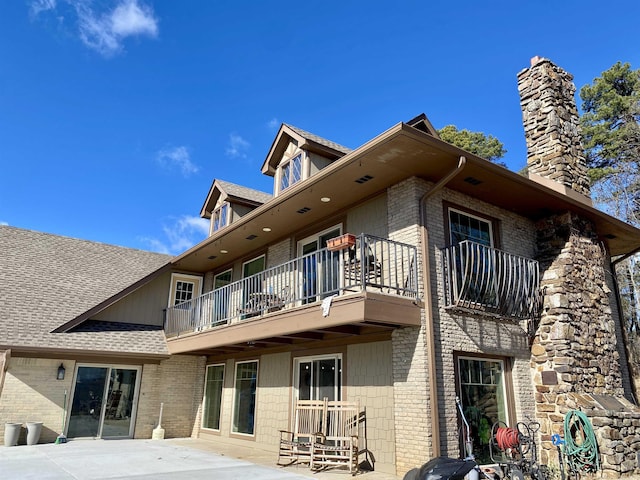 back of house featuring a patio and a balcony