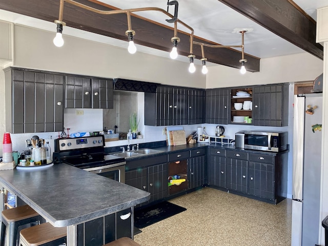 kitchen with sink, beam ceiling, hanging light fixtures, and appliances with stainless steel finishes