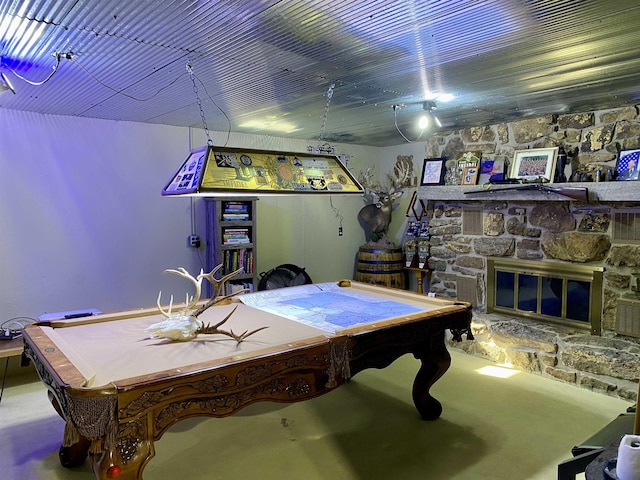 playroom with a fireplace, pool table, and concrete flooring