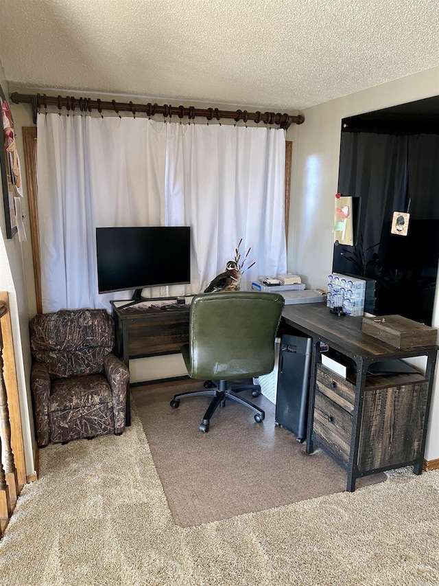 carpeted office space featuring a textured ceiling