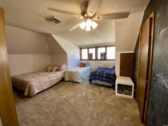 bedroom featuring ceiling fan, carpet, vaulted ceiling, and a textured ceiling