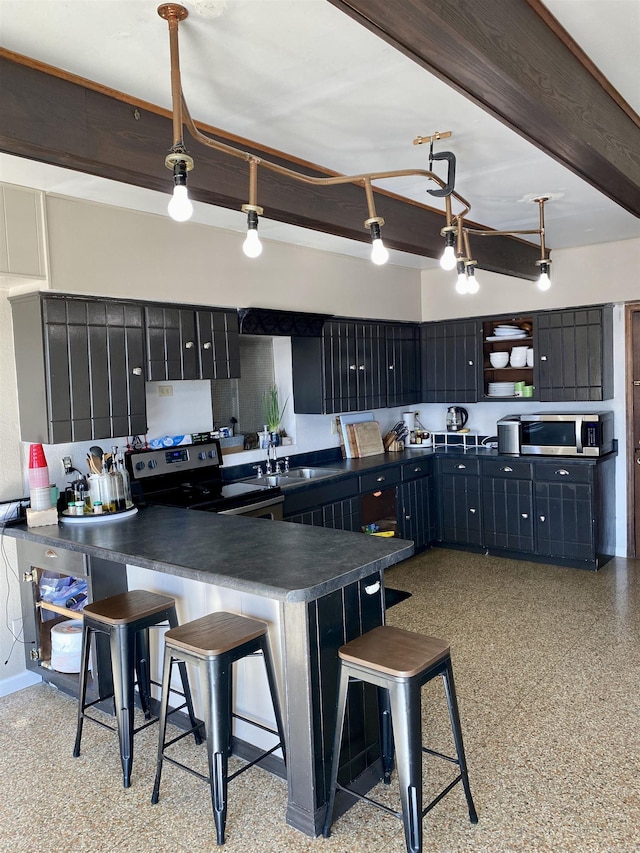 kitchen with beamed ceiling, a kitchen bar, hanging light fixtures, sink, and stainless steel appliances