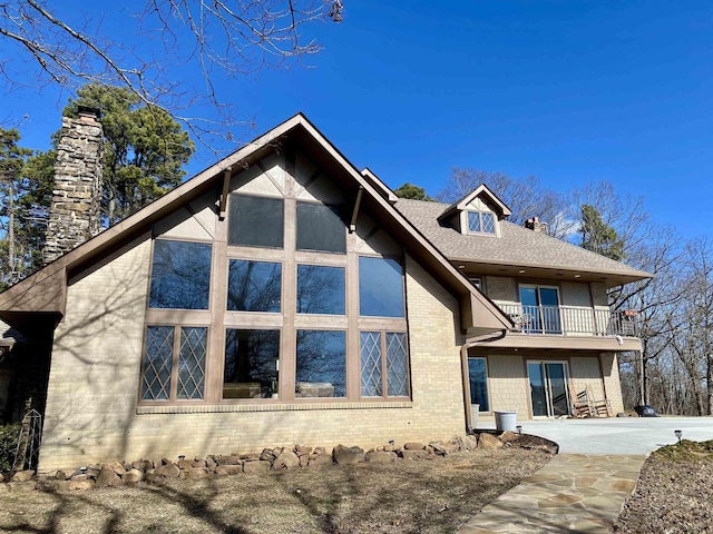 view of front of home with a balcony and a patio